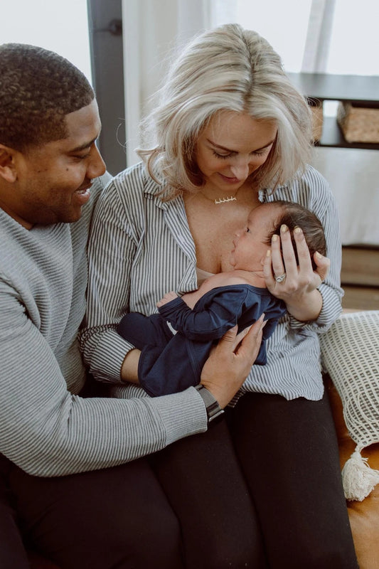 Mom and dad snuggle with their baby. 
